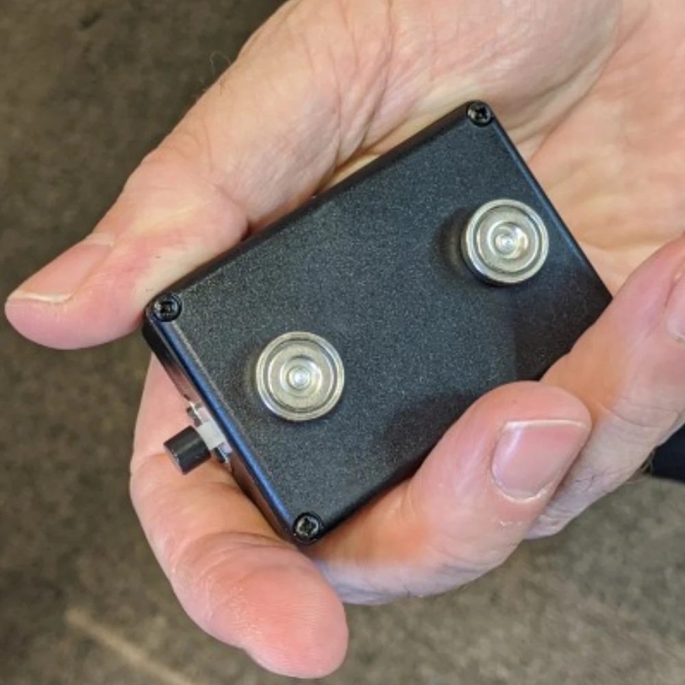 Black Vox 365 magnetic voice recorder held in hand, showing the two magnets
